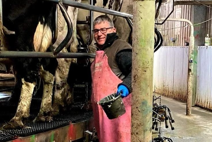 A man in a milking shed.