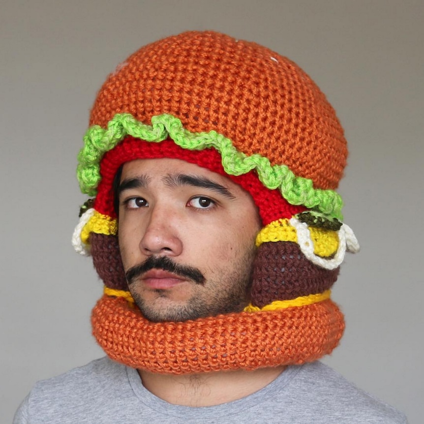 Chili Philly wearing a crocheted burger hat.