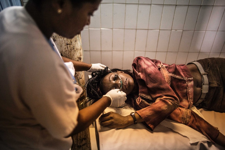 A wounded protesters is treated at a hospital in Libreville on September 1, 2016.