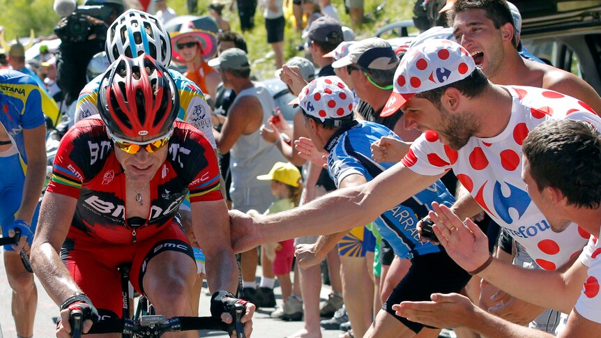 BMC Racing Team rider Cadel Evans of Australia is cheered by spectators during the 16th stage.