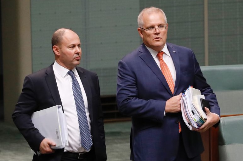 Josh Frydenberg and Scott Morrison entering the House of Representatives holding folders and documents.