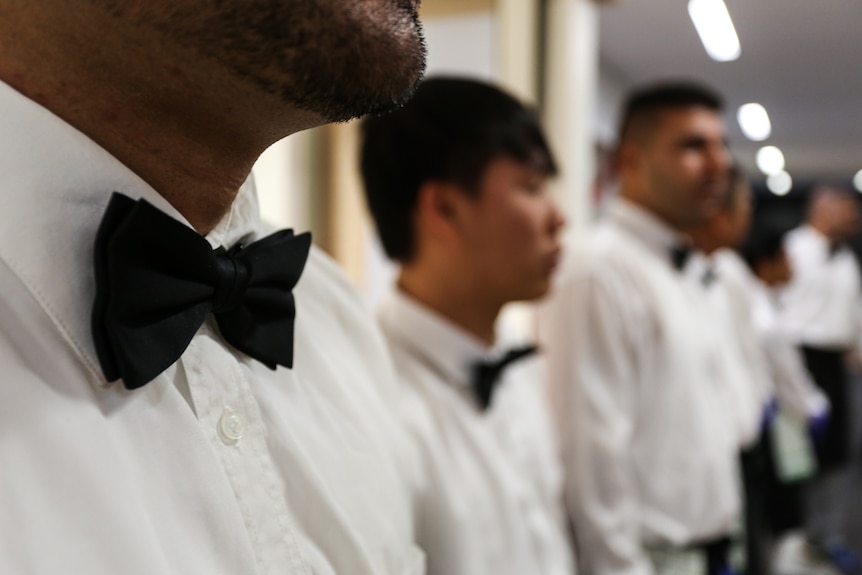 A close up of a row of black ties worn by the prisoners.