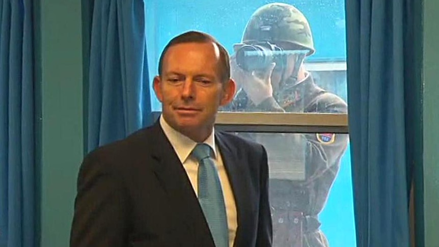 A North Korean soldier photographs Prime Minister Tony Abbott during Mr Abbott's visit to the demilitarised zone.