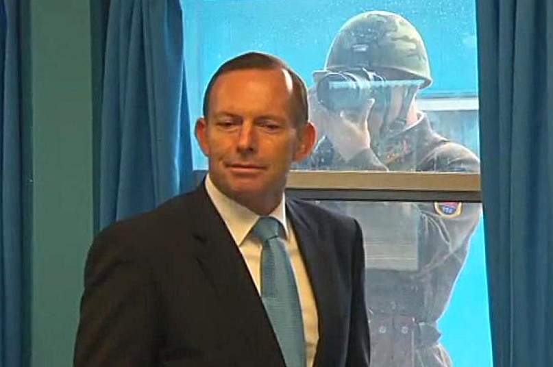A North Korean soldier photographs Prime Minister Tony Abbott during Mr Abbott's visit to the demilitarised zone.