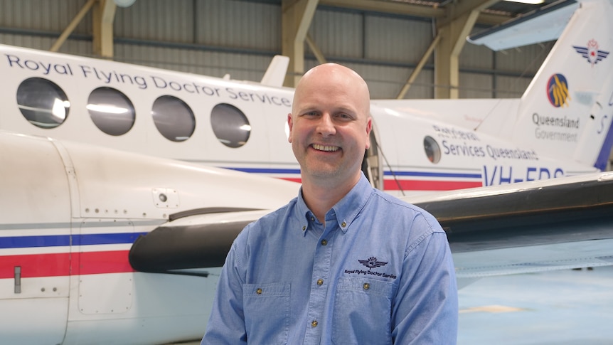 Man stands in front of plane