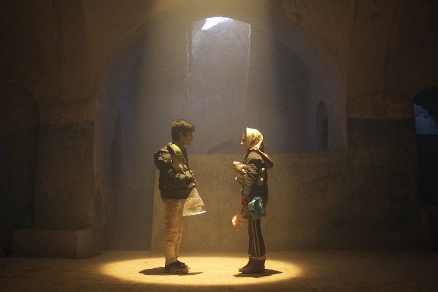 image of a little girl and boy in dimmed light 