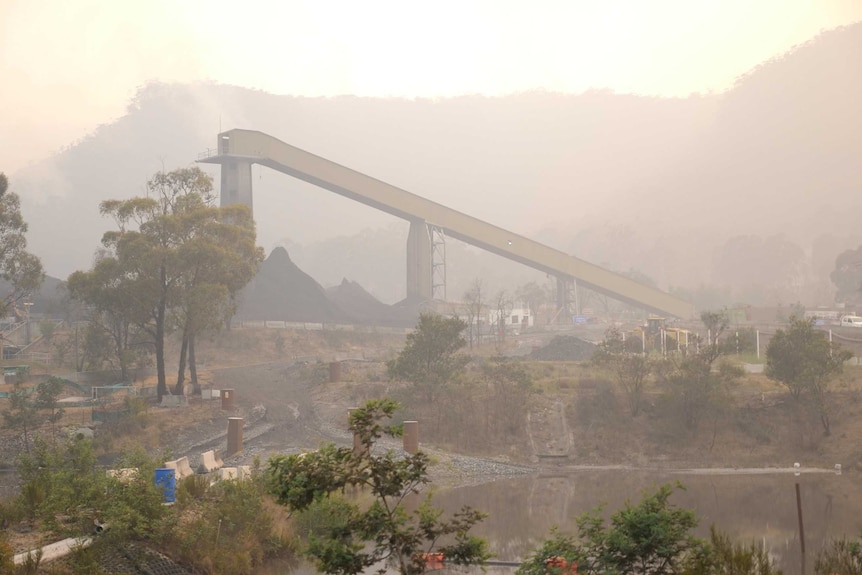 a smoky image of a distant coal mine