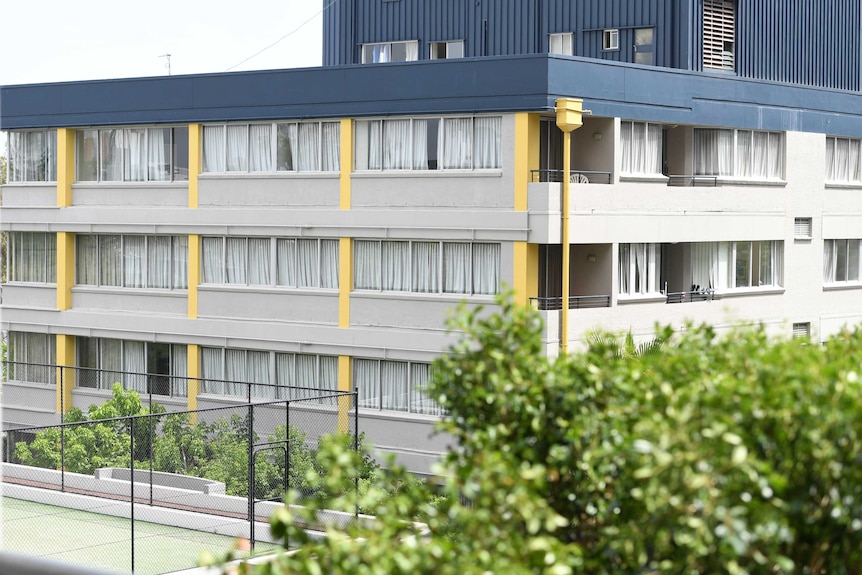 The Chasely Apartments Hotel in Auchenflower stands with nearly all curtains closed as police investigate.