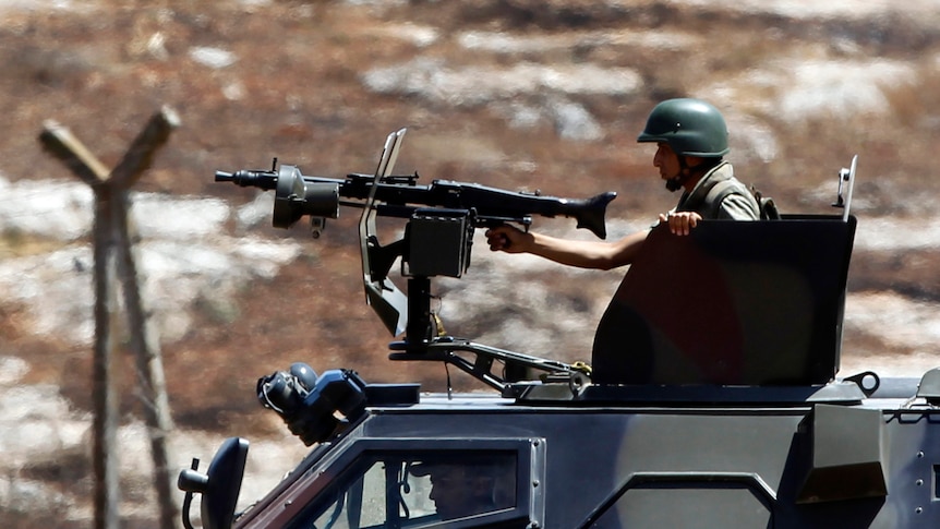 Turkish soldiers in a military vehicle patrol on the Turkish-Syrian border in the town of Reyhanli.