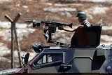 Turkish soldiers in a military vehicle patrol on the Turkish-Syrian border in the town of Reyhanli.