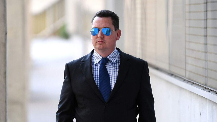 Ipswich lawyer Cameron McKenzie, wearing sunglasses, outside the District Court in Brisbane on July 17, 2019