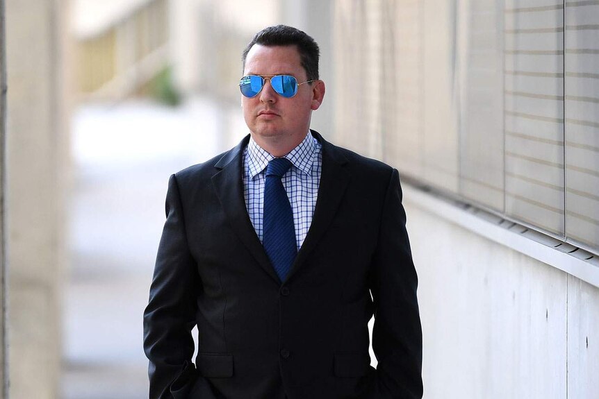 Ipswich lawyer Cameron McKenzie, wearing sunglasses, outside the District Court in Brisbane on July 17, 2019