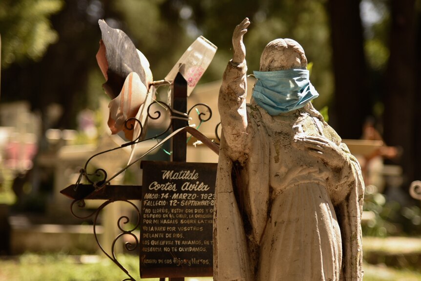 On a grave in the cemetery in Xochimilco, an angel statue wears a face mask in recognition of the pandemic.