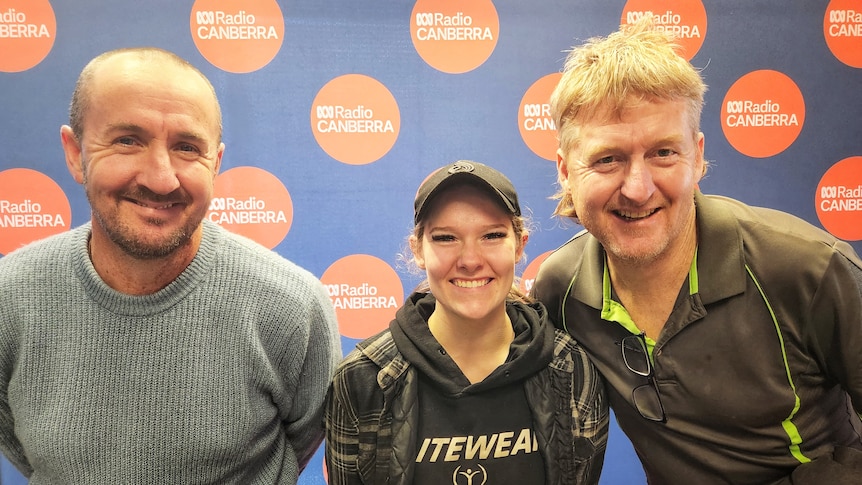 Two men and a woman smile in the ABC Radio Canberra studio