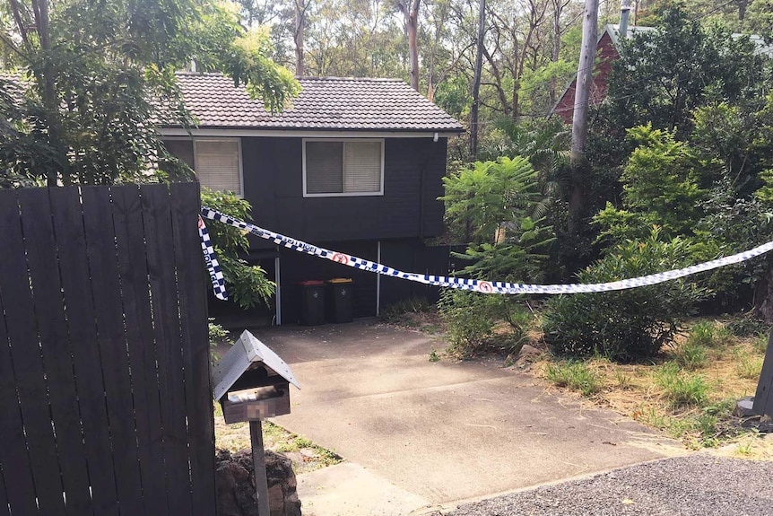 House with police tape across driveway in Fig Tree Pocket Road at Chapel Hill in Brisbane.