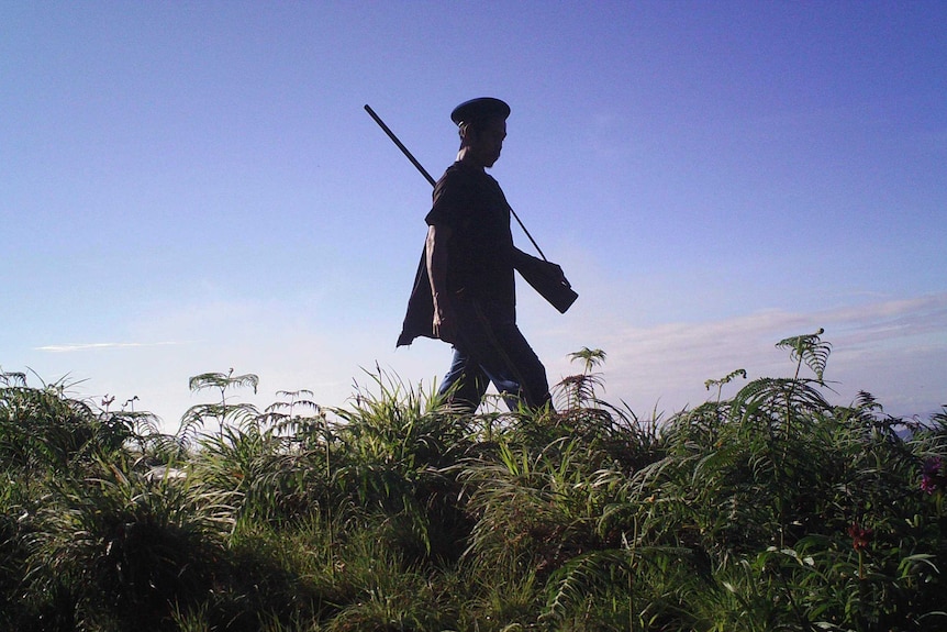 Poacher silhouetted