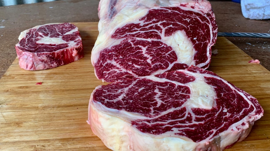 Thick cuts of beef on a chopping board