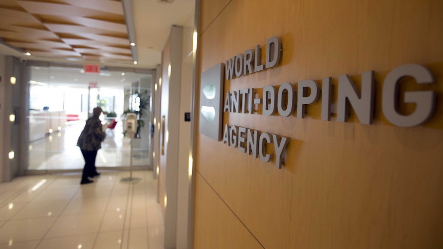 A woman walks into the head office for the World Anti-Doping Agency (WADA) in Montreal.