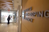 A woman walks into the head office for the World Anti-Doping Agency (WADA) in Montreal on November 9, 2015.