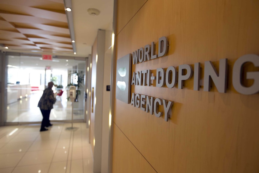 A close-up shot of the wall of an office, with the sign "World Anti-Doping Agency"