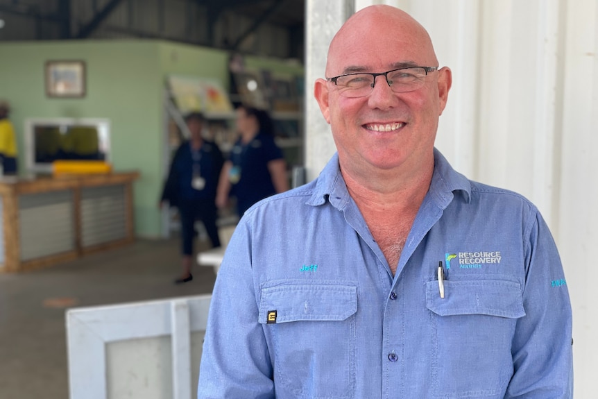 A smiling man in a blue shirt