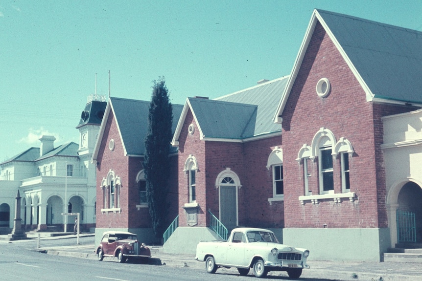 A street scene on a sunny day taken in the 1950s