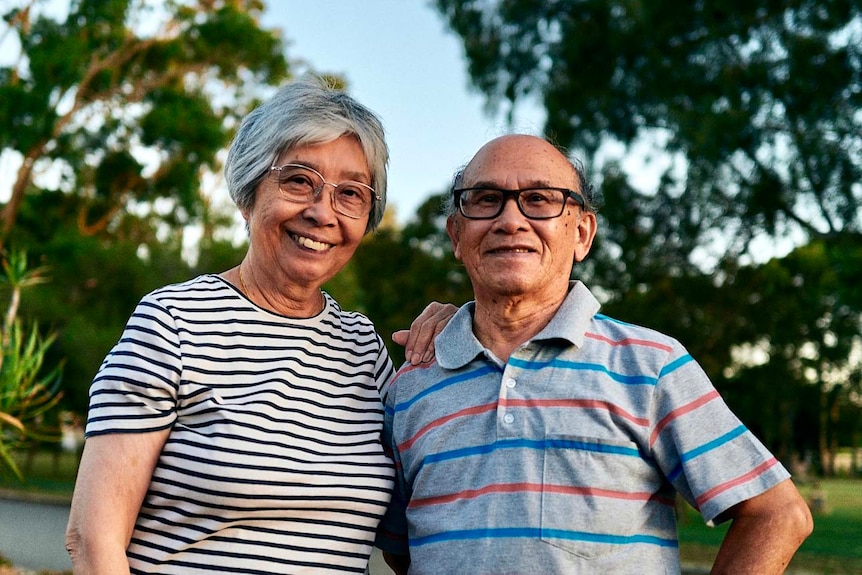 A close up portrait photo of Vincent and Kwan Chan standing in a leafy street