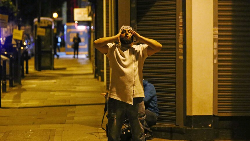 A man prays after a vehicle collided with pedestrians near a mosque in the Finsbury Park neighbourhood of North London.