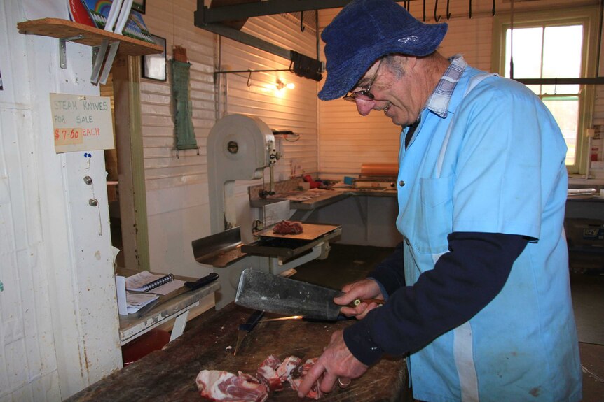 Paul 'Spud' Bennett cutting to the final off-cuts in his butcher shop.