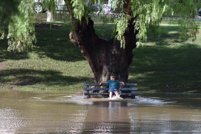 A boy in Geelong enjoys the water after flood waters recede