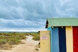 Stormy photo of beach with colourful beach shack.