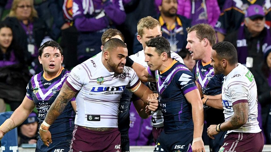 Billy Slater pulls Dylan Walker from out of a brawl in Melbourne's match against Manly at AAMI Park.