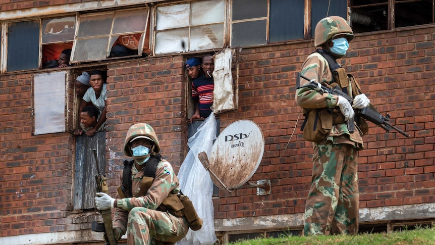 South African National Defense Forces patrol the Men's Hostel in the densely populated Alexandra township east of Johannesburg.