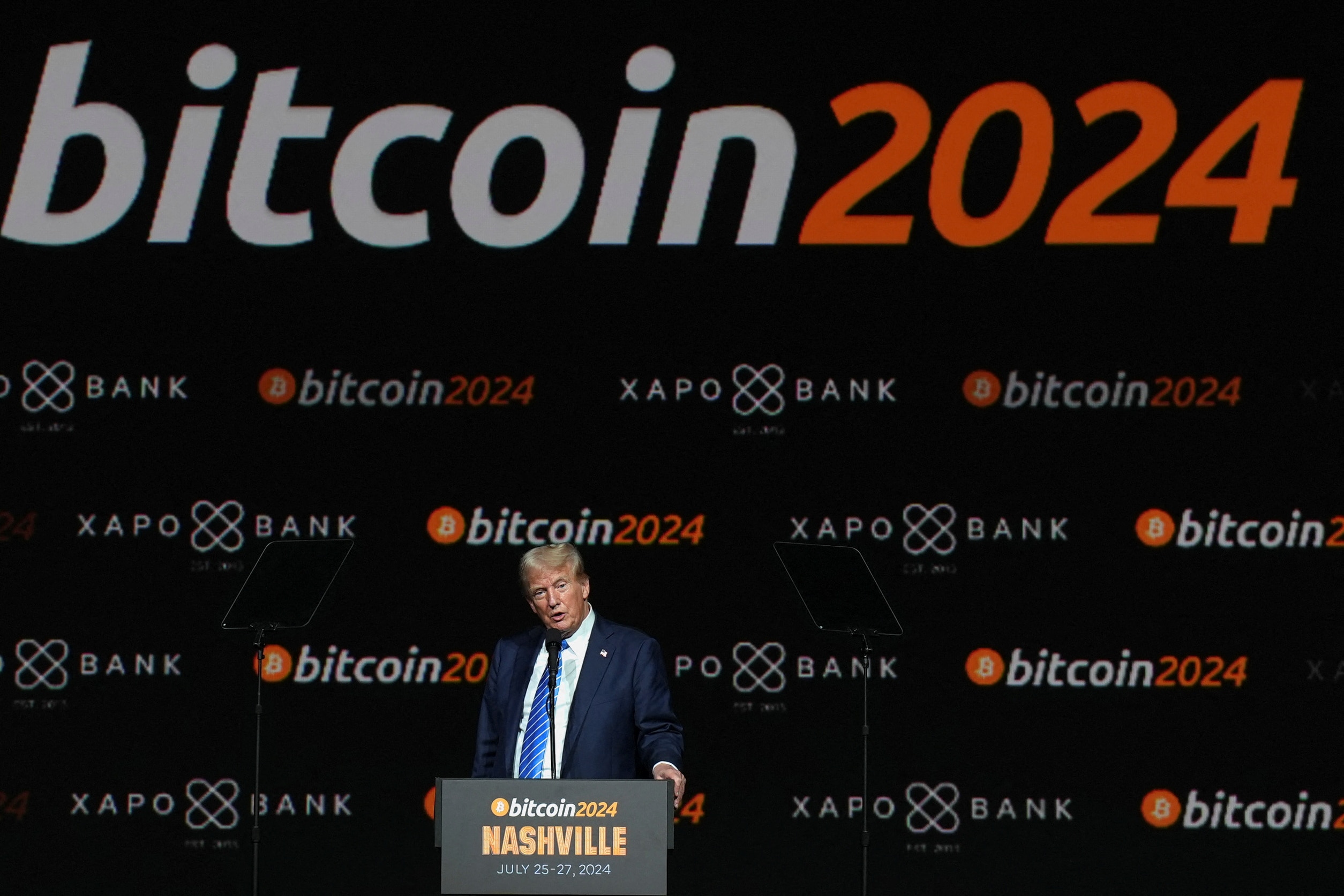 Donald Trump at podium, in front of bitcoin 2024 signage