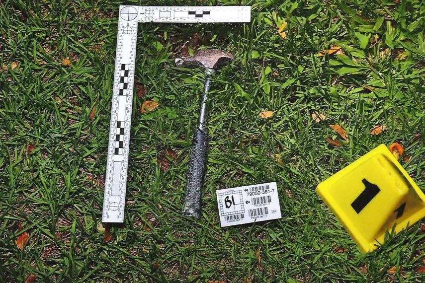 .Hammer on grass at crime scene outside home of Andrew and Kym Cobby at Worongary.