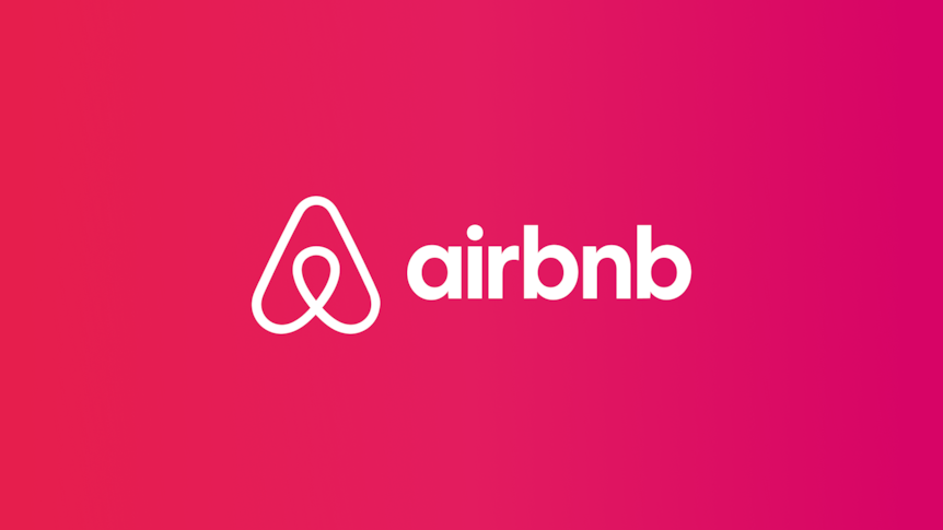 Airbnb's logo and branding in white on a pink background. 