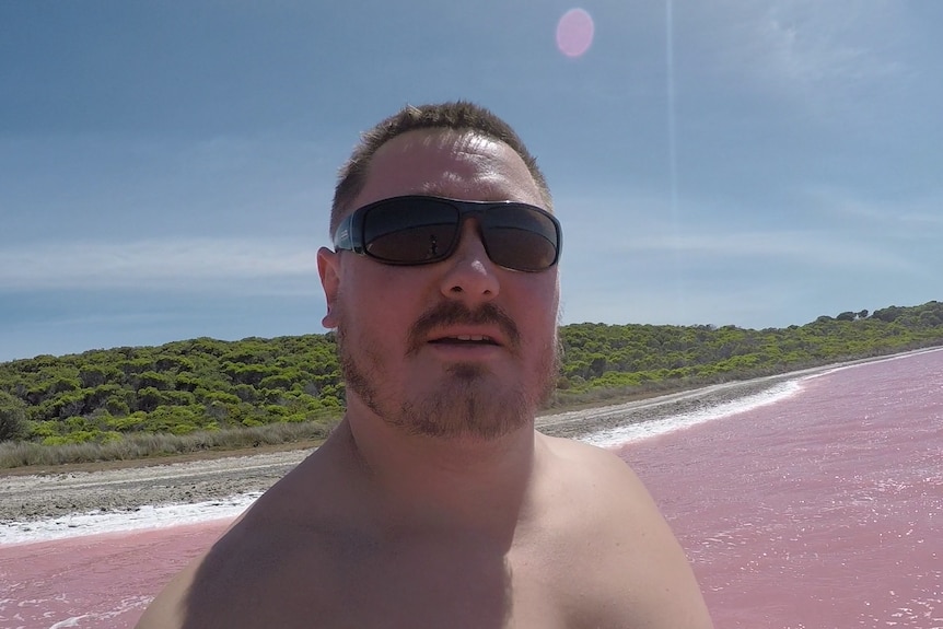 Ken McGrath selfie with the pink Lake Hillier in the background