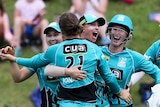 Brisbane Heat WBBL players embrace and high-five after Haidee Birkett's stunning catch on the boundary