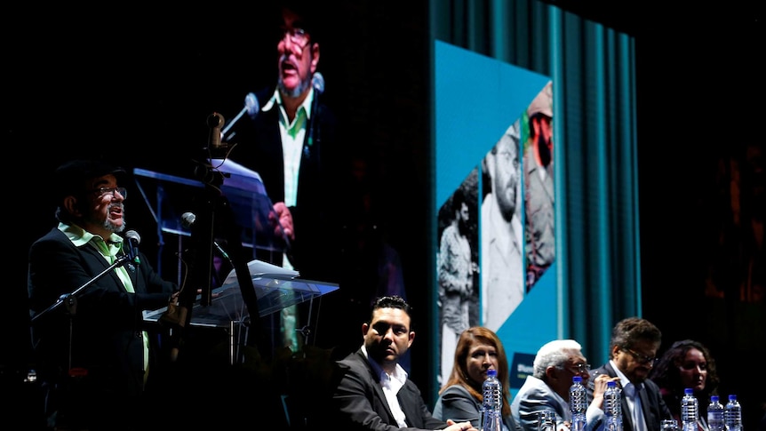 Colombia's Marxist FARC rebel leader Rodrigo Londono speaks on stage.