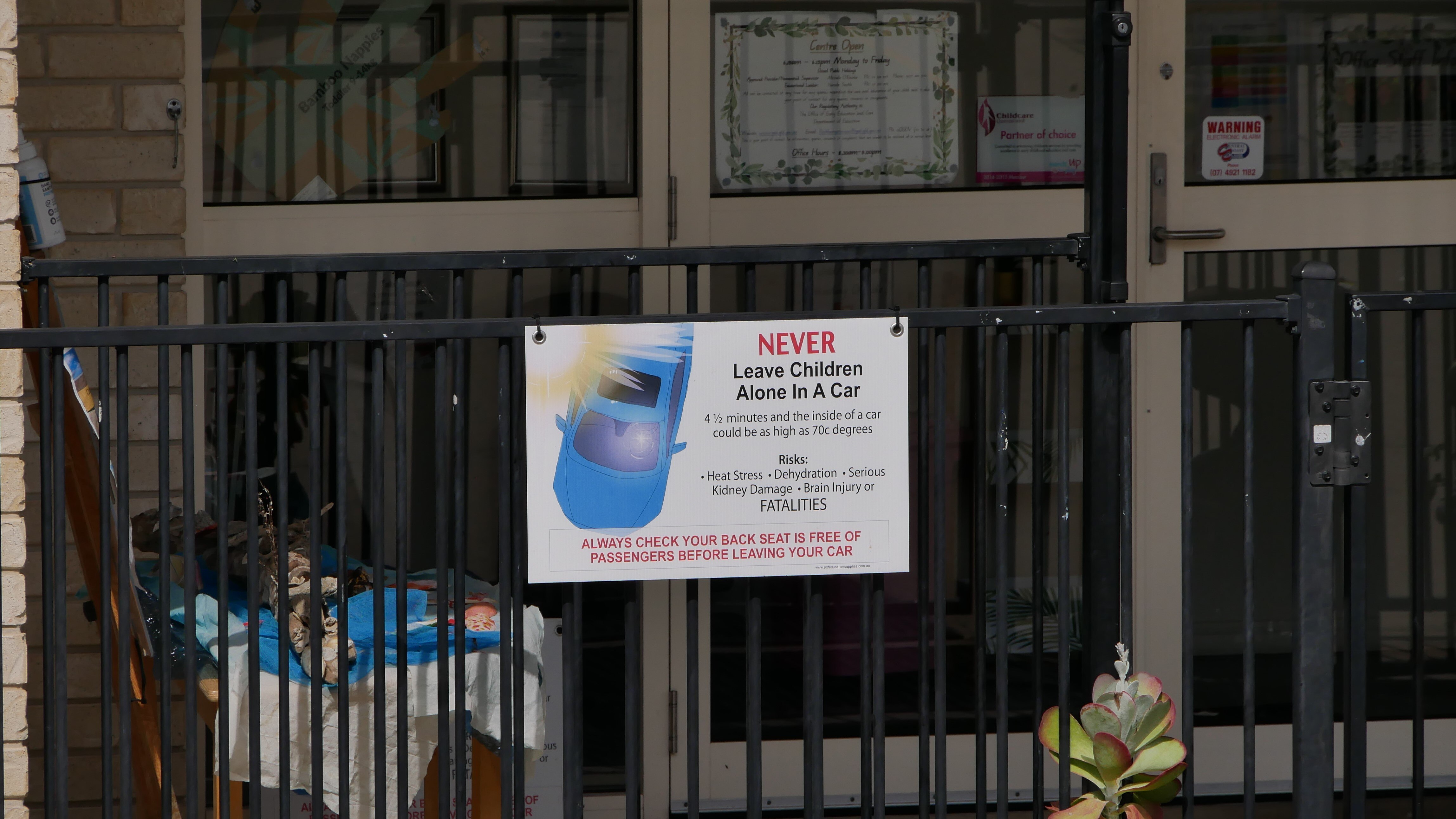 A 'don't leave your kids in the car' sign out the front of daycare centre.