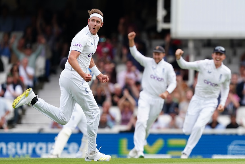 Stuart Broad looks back at the umpire while running as teammates celebrate behind him