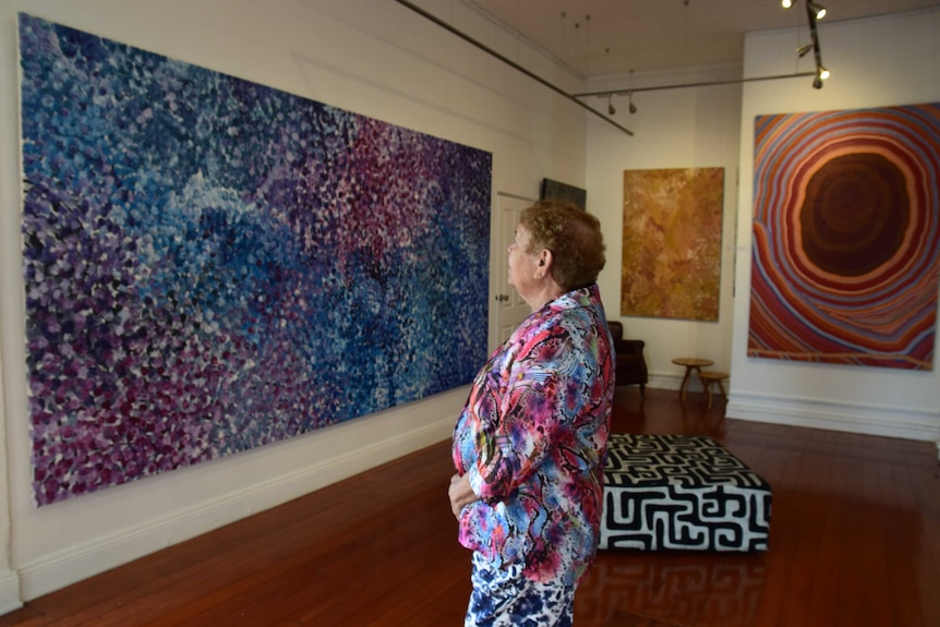 Barbara Weir looks at a painting by Emily Kngwarreye at the Kate Owen Gallery