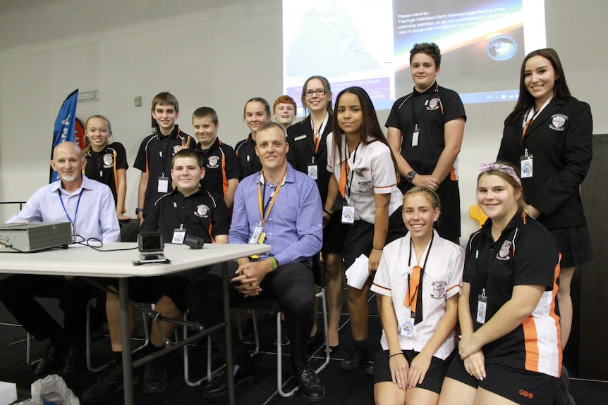 Shane Lynd and Matt Barber with Glenmore State High School students in Rockhampton get ready to make their phone call to space.