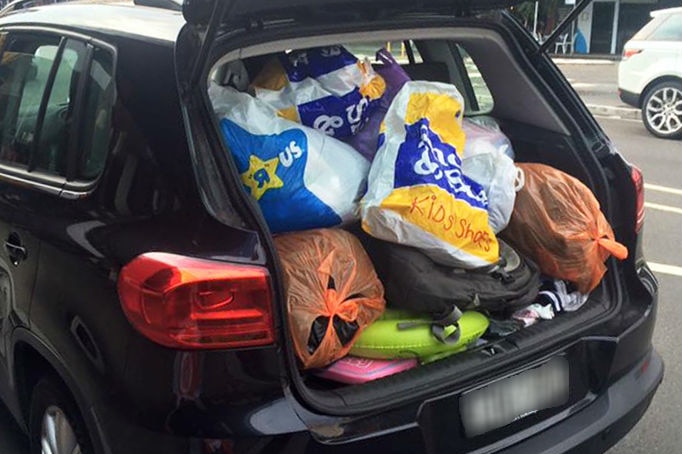 A car boot full of bags of clothing