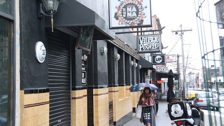 A woman walks past Ichi Ni Nana restaurant on Brunswick Street in Fitzroy.