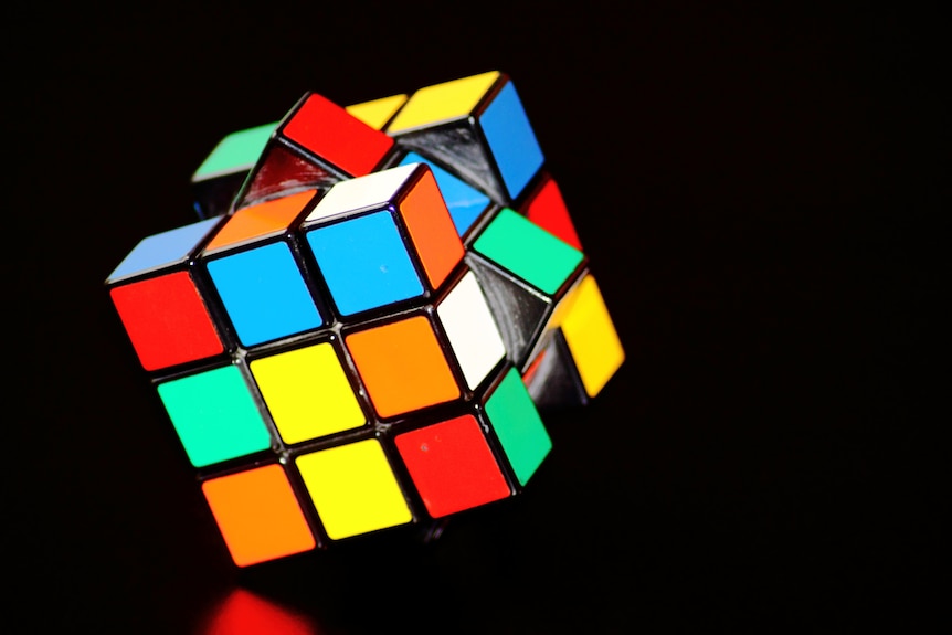 A picture of a Rubik's Cube with different coloured squares rotating. 