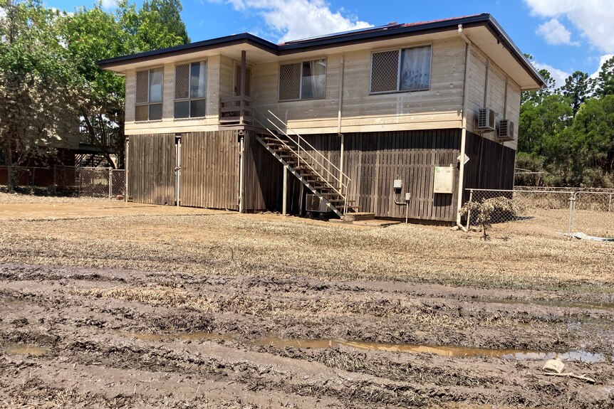 A goodna house with mud all around it after water recedes.