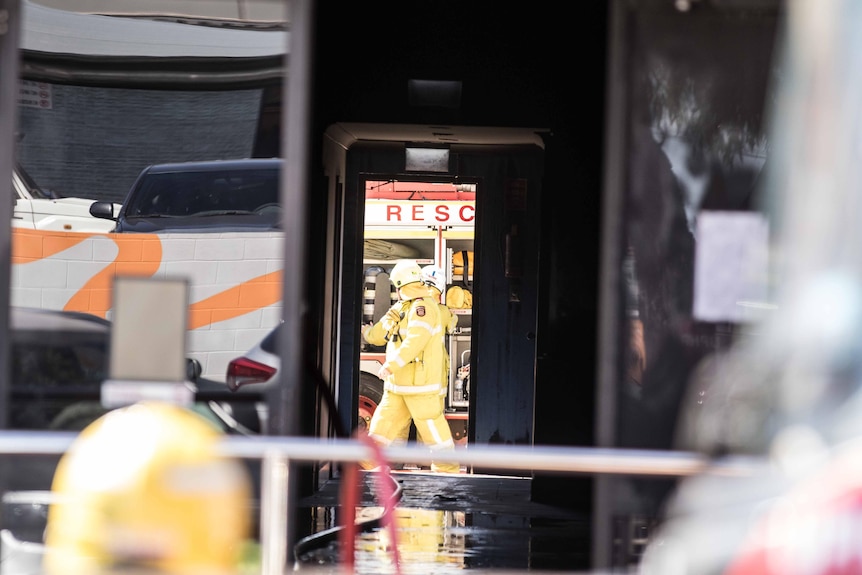 Firefighters checking hoses inside a building which was on fire.   