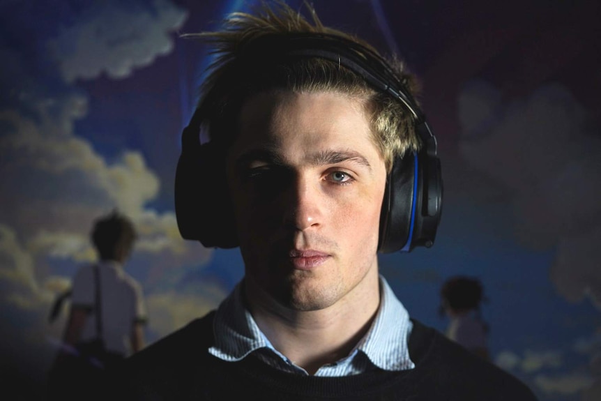 A head-and-shoulders profile shot of Alex Ridley, who plays esports under the name 'NaviOOT', wearing headphones.