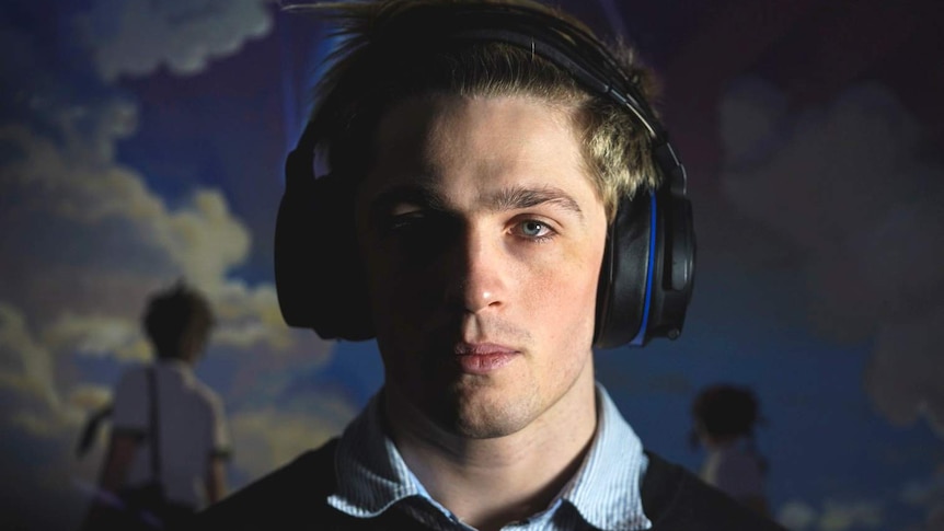 A head-and-shoulders profile shot of Alex Ridley, who plays esports under the name 'NaviOOT', wearing headphones.